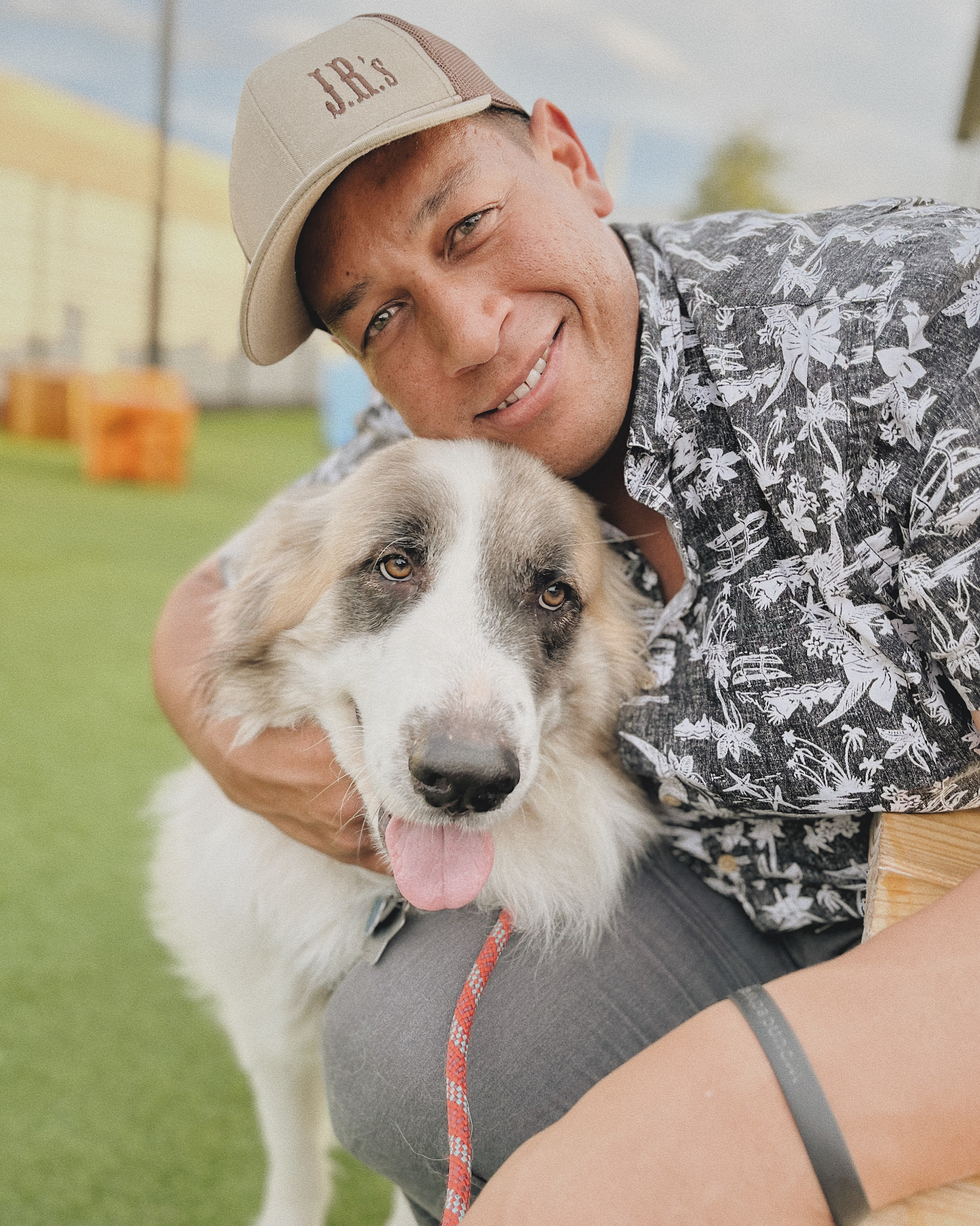 Ben with Duke, one of the Great Pyrenees the company is named after, on turf at JR's Pet Ranch